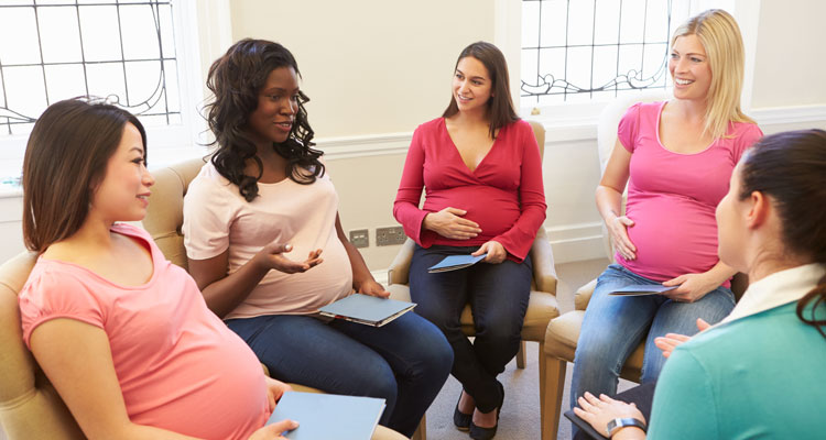 Pregnant Women Meeting At Pre Natal Class, sitting in a circle