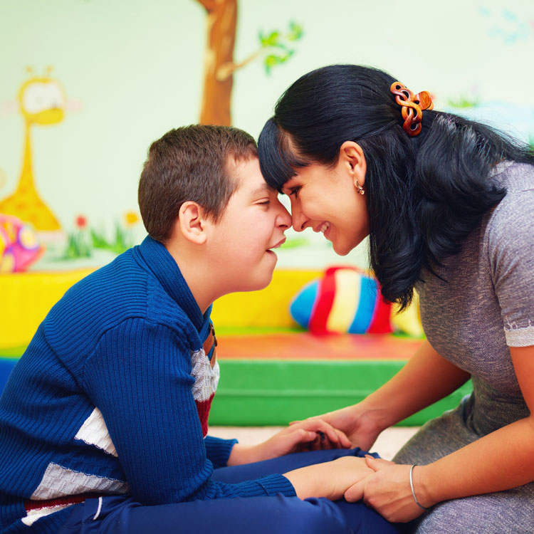 mother and her son with disability in rehabilitation centre