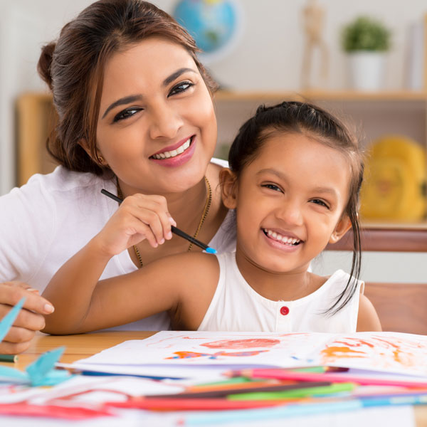 Smiling teacher and student, creating art