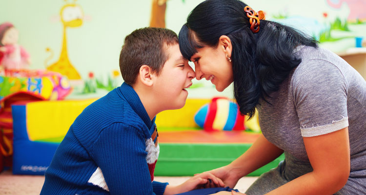 mother and her son with disability in rehabilitation centre